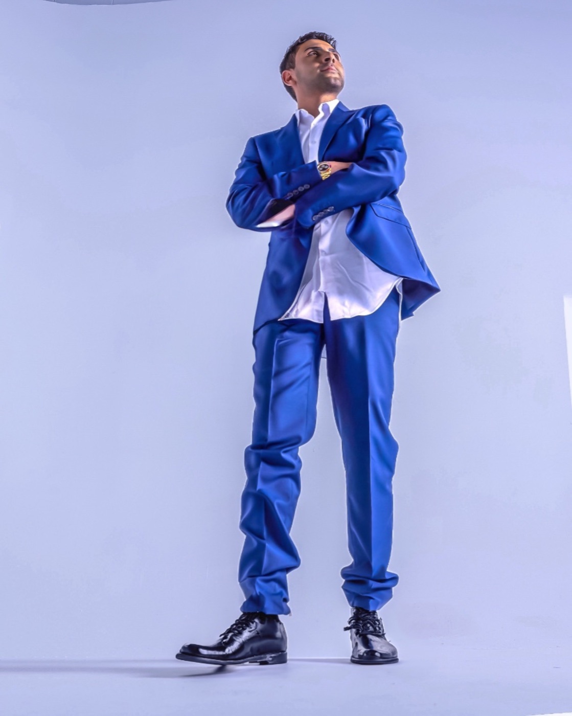 Adam Zak in a blue suit in a studio portrait